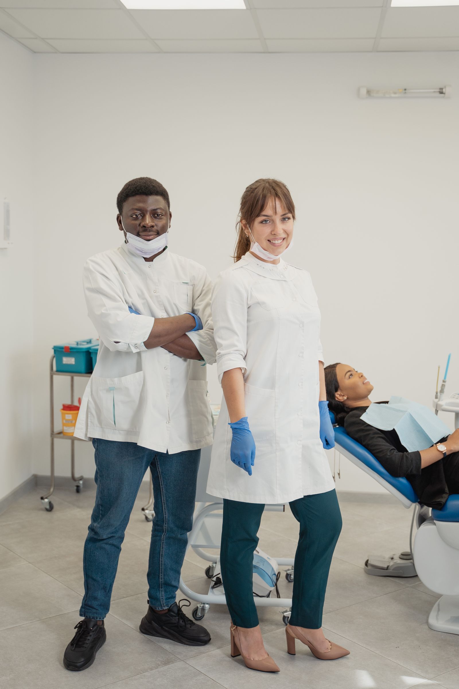 Friendly dental team standing with a patient in a bright clinic