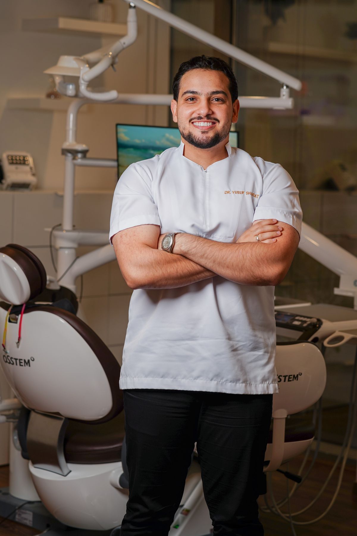 Stock portrait of a male dental clinician in a treatment room